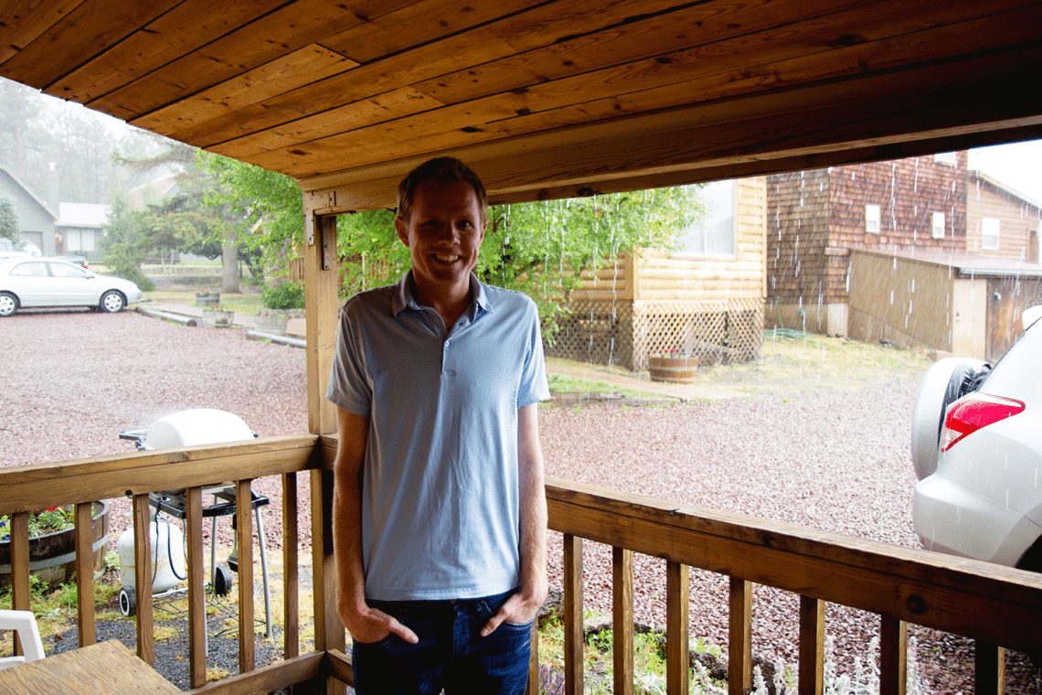 Man in front of a cabin in Greer.